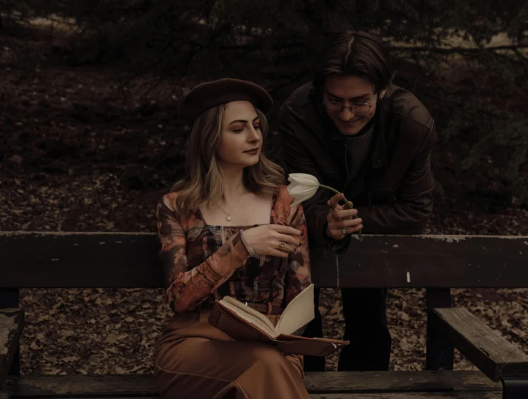 A quiet emotional moment between a woman and a man holding a flower, symbolizing relationship patterns, awareness and reflection.