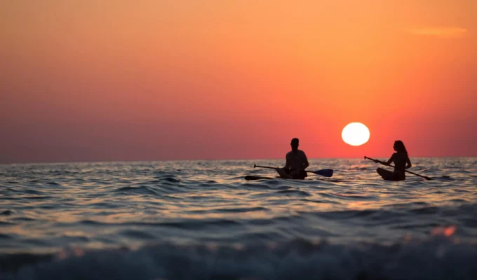Couple kayaking at sunset, symbolising emotional connection and self-discovery in relationships