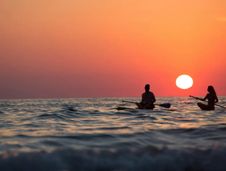 Couple kayaking at sunset, symbolising emotional connection and self-discovery in relationships